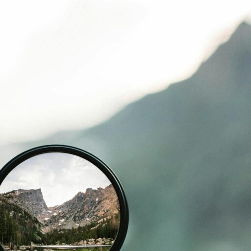 A stunning mountain landscape magnified through a handheld lens highlighting exploration and adventure.